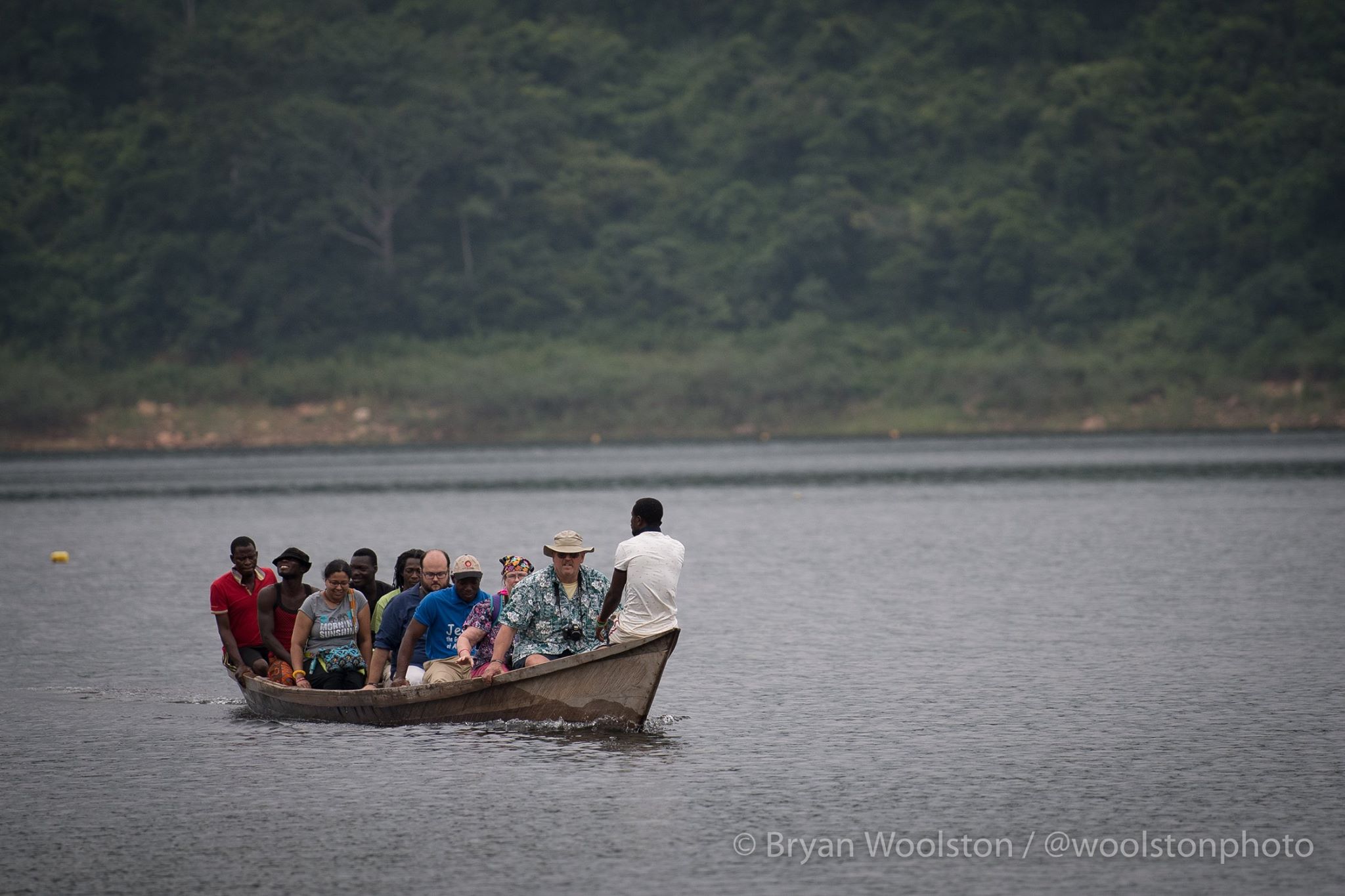 A group photo of bunch of people riding a boat